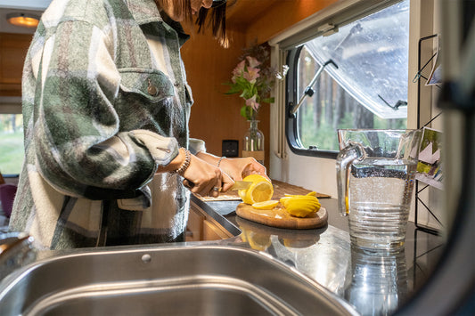 Woman making lemonade in RV kitchen